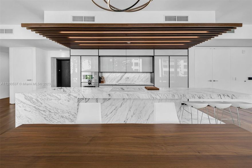 Spacious corner, 3-bedroom, 3.5 bathroom with wraparound terrace featuring views of Biscayne Bay and the Atlantic Ocean.   Calacatta kitchens with dramatic sculptural marble island. Bathrooms with richly veined, stone countertops, marquetry flooring and tiled walls. Other notable features include custom cabinetry & built-in features, designer fixtures, teak flooring throughout & private elevator. Monad Terrace is 59 individually designed waterfront residences around a glittering lagoon, designed by Pritzker Winner, Jean Nouvel providing brilliant light, climbing gardens, unique sawtooth honeycomb facades & stunning sunset views.