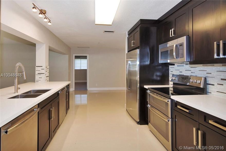 Completely renovated & modernized 4/2 in the heart of Emerald Hills. New roof, new gutters, new 24x24 rectified porcelain floors, gray modern laminate in bedrooms, new kitchen quartz countertops, custom wood cabinets, 2x dishwashers, dble oven, dble sink, professional faucet, large breakfast area, kitchen open to family room with quartz bar, his and her's closets in master, all new modern bathrooms, new landscaping & irrigation system, new pergola, large yard room for a pool, circular driveway.