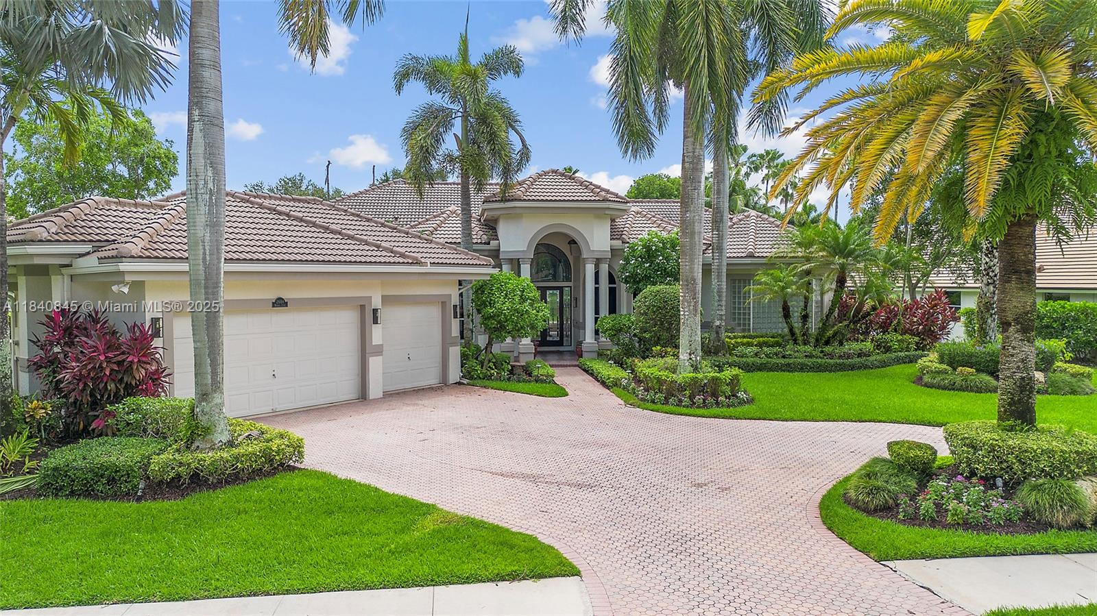 Set on oversized 20,437 sqft lot in Weston Hills CC most exclusive street. This custom estate is an entertainer’s retreat overlooking the Tour Course’s 10th hole. 2018 roof crowns 5 BD/5.5 BA of refined living with marble and hardwood floors, soaring ceilings, fireplace, wine room, flex room, and garage storage. Chef’s kitchen features Sub-Zero, Thermador, and Bosch appliances, center island, double wall oven. Luxe primary suite adds sitting area, office/exercise room, expansive walk-in closet with fitted wardrobe, vanity, and spa bath with steam shower, marble and Jacuzzi. Sun-splashed interiors frame the fairway views, while outside resort-style saltwater pool and spa share paver deck with summer kitchen, built-in grill, and dual pizza ovens. Fully fenced yard with gate to the course.