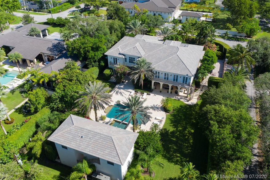 Splendid Ponce-Davis ESTATE has it all: Timeless, transcendent architecture; gated builder’s-acre corner lot; enchanting, resort-style setting. Old Florida meets Modern Miami in the trend-defying, grandly scaled 9,474SF Smart Home distinguished by stately, classic lines, soaring entry & exquisite craftsmanship. Features: Elevator, impact windows/doors, high ceilings, marble floors, masterful woodwork. Heart-of-the-home Kitchen, Breakfast rm, formal Living & Dining rms; Family rm w/XL Bar & Wine Cellar; Game & Media rms. Breathtaking Master w/Office, His&Hers closet, luxe Bath w/2 WCs; expansive en-suite Bdrms; Laundry rm, 3-car Garage. Covered outdoor kitchen, Pool w/Spa, mature Landscape. +1,710SF Guest House! Prime location near shops, dining, schools & parks. Ponce-Davis paradise found!