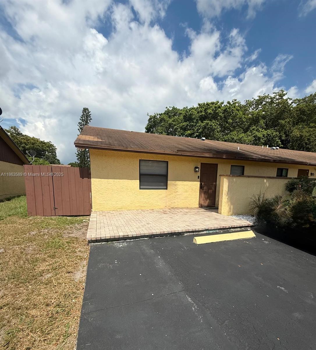 Renovated move-in ready 3 bedroom/2 bathroom, with granite countertops and SS appliances, hurricane Impact windows and doors, fenced-in backyard with outdoor kitchen and 1 of the room has it's own entryway. Laundry room with washer and dryer included, nice paver front and back patios. Ceramic tile throughout, ample private driveway for 4 cars. Offers Community Clubhouse with pool, jacuzzi, tennis court, ping pong and more. Lots of room to entertain family and friends. Close to shops and the beach, and easy access to both I-95 and The Turnpike.