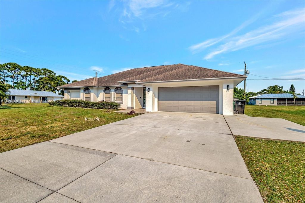 Photo of 1321 SE Airoso Blvd, Port Saint Lucie, FL 34983 (MLS # A11768364)