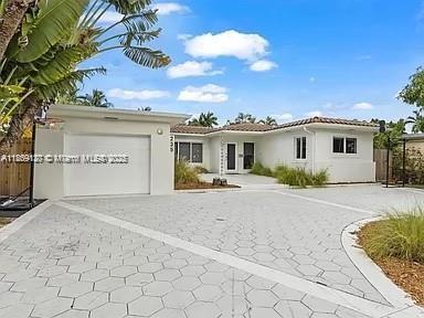 Beautiful light and bright pool home in a gated residential golf course community in Normandy Island that will not disappoint. House has a great open floor plan in the living areas with lots of light and a split bedroom plan. The kitchen is large and open with stainless steel appliances, laminate countertops and plenty of room to entertain or just eat in. Roof was redone in 2011 and impact windows have been updated. Pool is a great size with a large tiled patio area with tropical plants surrounding. House is in an amazing location across the street from Normandy Golf Course and only a block away from the renovated Fairway Park. The island also has 3 tennis courts on the bay and a newly renovated golf course, clubhouse and pool. Restaurants and shopping all close by.