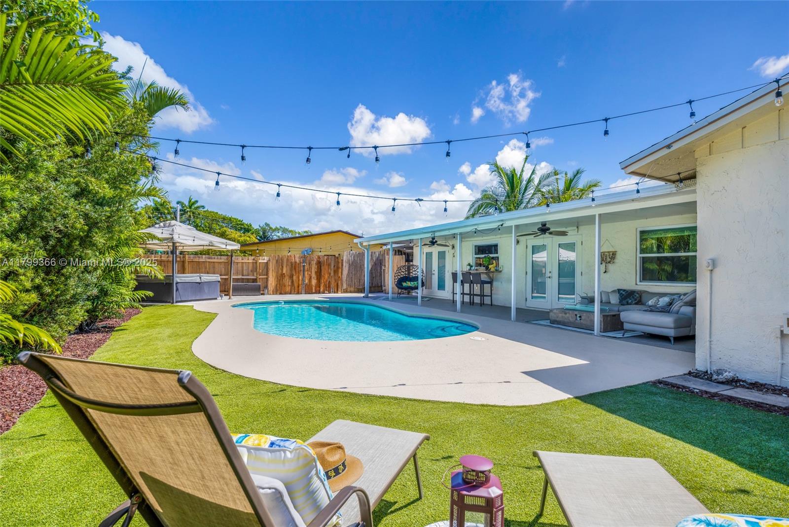 Renovated 3-bed, 2-bath pool home in highly desirable Palm Aire Village East with no HOA! This light-filled home features vaulted ceilings, open layout, and modern finishes throughout. The stunning kitchen offers quartz countertops, a spacious island, and stainless steel appliances. Travertine and wood laminate flooring add warmth and style. Step outside to your private entertainer’s patio with resurfaced pool, outdoor shower, and lush tropical landscaping. The side covered area is perfect for a workshop or extra storage. Fully fenced backyard for privacy. Additional features include impact windows and doors, a 2-car garage with epoxy floors, and circular driveway with extra parking. Minutes to I-95, parks, Publix, dining, and Calvary Christian Academy.