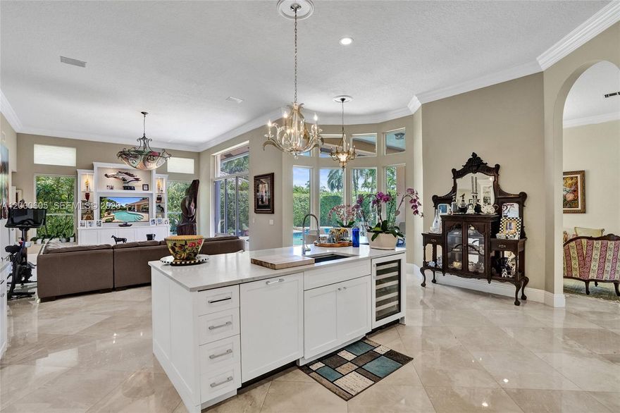 Do you need a huge primary bedroom closet? How about an impeccably designed kitchen? Well here it is! Come take a looked at this beautifully updated pool home in Boca Isles North. Features include a built-in Viking refrigerator, Bosch cooktop, double wall ovens, 24" polished Botticino marble floors, 9'' crown molding, 7'' baseboards, and 3.5'' door casings, and whole house generator. All three bathrooms have been redone with the finest marbles and materials. Hand scraped African Mahogany hardwood floors in bedrooms, pool with glass mosaic tile and travertine coping, Grand Cayman Model.