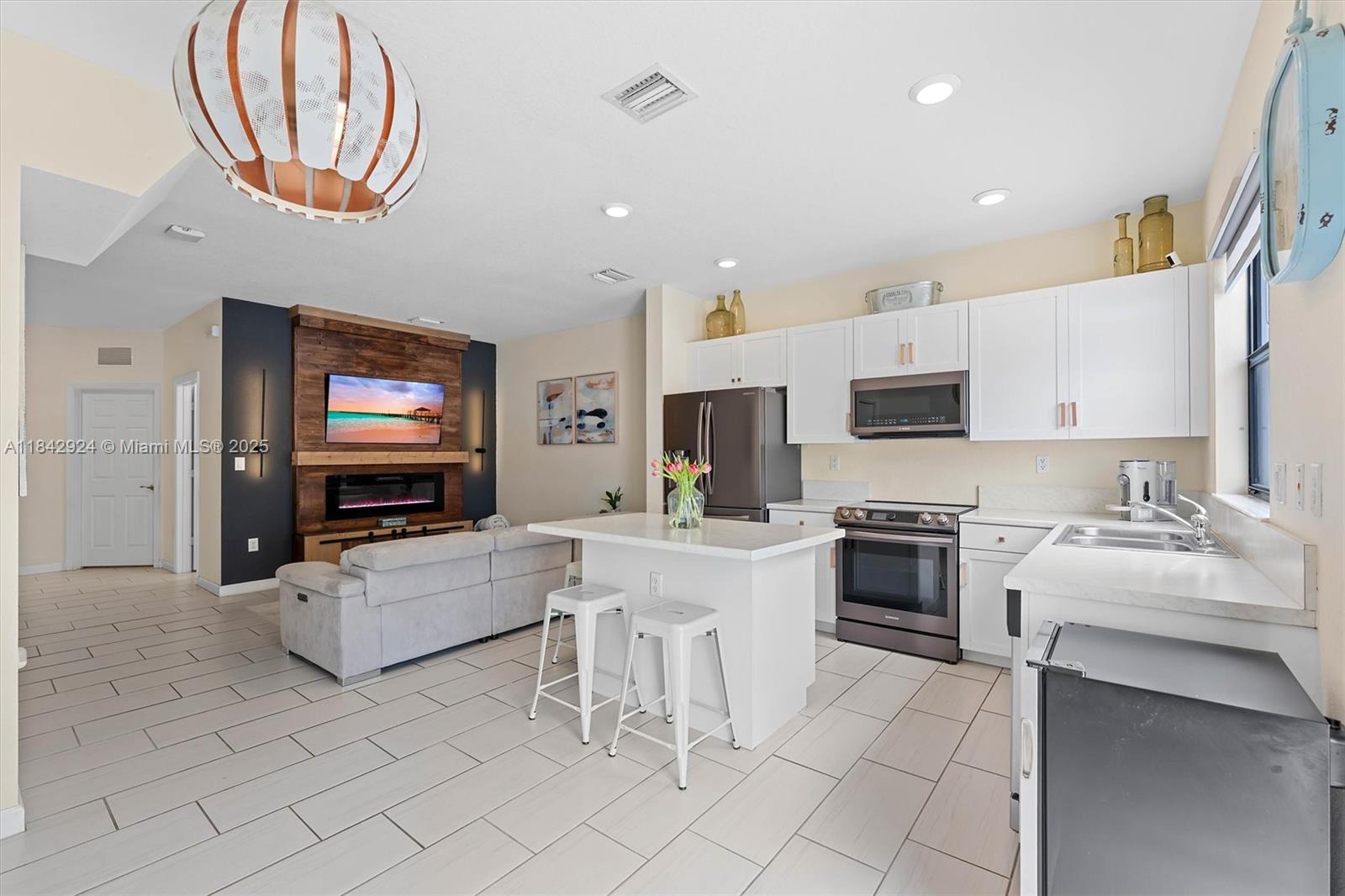 Open House on August 2nd from 12-2pm | Welcome to this beautifully maintained 3-bed, 3-bath townhome in the gated, resort-style community of Aquabella! The open kitchen with stainless appliances seamlessly flows into a spacious living area and a private paved patio that backs to open landscape—no rear neighbors—making it ideal for relaxing or entertaining outdoors. Enjoy tile floors downstairs, freshly cleaned carpet in bedrooms, and a convenient first-floor bedroom ideal for guests, office or multigenerational living. Each bedroom is an en-suite with its own full bath. Home includes upgraded appliances, custom zebra blinds, and smart home features. With two clubhouses, pools, two gyms, kids' splash zone, and year-round community events—you’ll never want to leave!