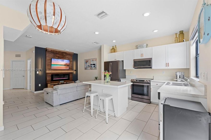 Buyer can assume Sellers $260K FHA loan at 2.7%! Welcome to this beautifully maintained 3-bed, 3-bath townhome in the gated, resort-style community of Aquabella! The open kitchen w/ stainless appliances seamlessly flows into a spacious living area & a private paved patio that backs to open landscape, no rear neighbors—making it ideal for relaxing or entertaining outdoors. Enjoy tile floors downstairs, freshly cleaned carpet in bedrooms, & a convenient 1st floor bedroom ideal for guests, office or multigenerational living. Each bedroom is an en-suite with its own full bath. Home includes upgraded appliances, custom zebra blinds, & smart home features. With 2 clubhouses, pools, 2 gyms, kids splash zone, & year-round community events!