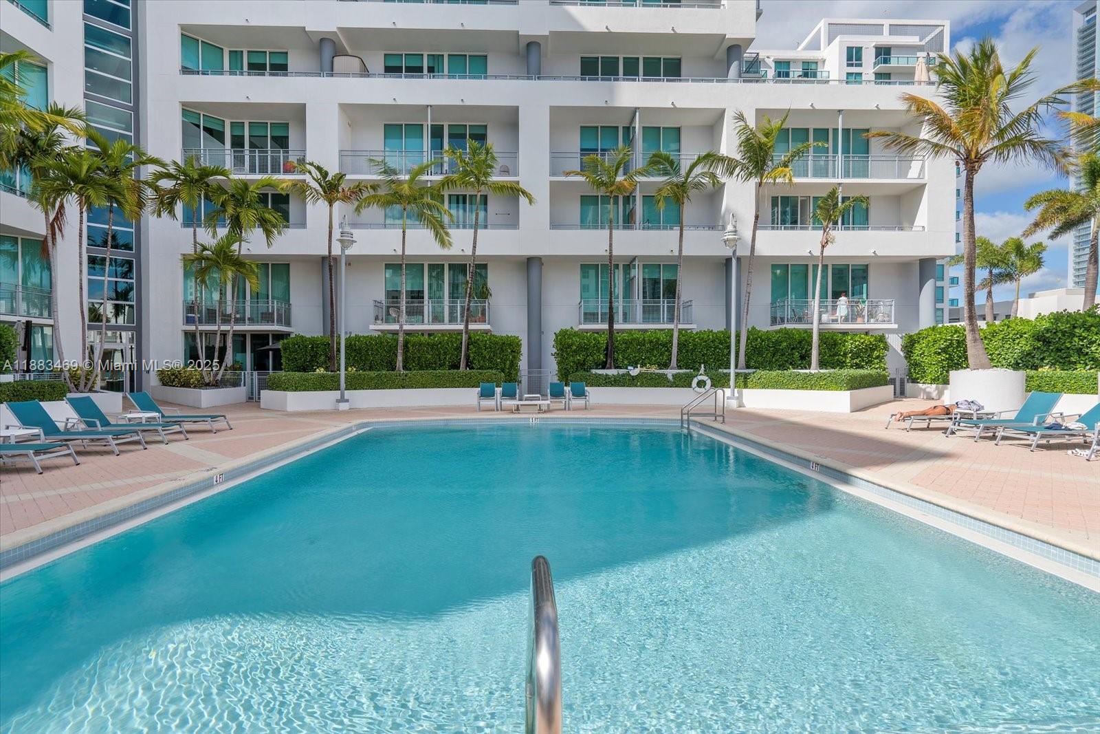 Prepare to be wowed by this stunning lanai unit! Amazing 2-bed 2-bath unit in a full-service building in the middle of Edgewater with an amazing 650+sqft private terrace overlooking the beautifully detailed tropical pool area. Split bedroom plan, open kitchen with quartz countertops and stainless-steel appliances is a chef's delight. Polished concrete floors, volume ceilings, floor-to-ceiling impact glass floods the space with natural light. The living area and bedrooms all open onto the hedge-lined private terrace on the pool deck, providing an incredible indoor-outdoor flow. Large washer/dryer in unit, dedicated 24-hour lobby attendant, pool, spa, gym, sauna, clubroom, billiard room, yoga room, business center, covered assigned parking, storage unit, on-site management.