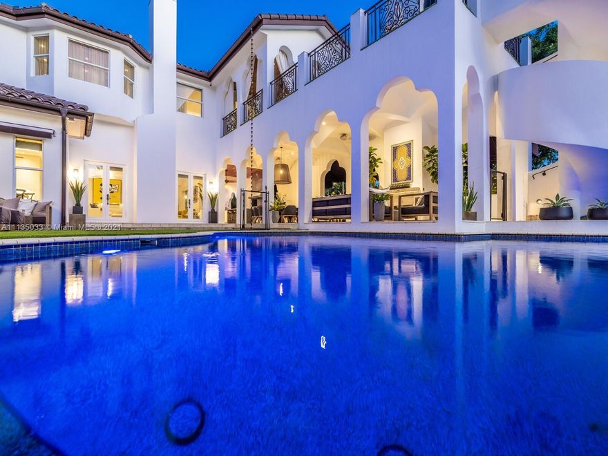 This Modern-Mediterranean resort style home is expertly designed for Miami entertaining, including a 2-bed Guest house! Impressive arrival through oversized doors lead to hacienda inspired courtyard with custom water fountain and koi pond, complete with viewing deck. Highly coveted covered outdoor entertainment area including full outdoor Mia Cuccina kitchen with top appliances. All new lush landscape, premium turf, and light system installation. Spectacular Lagoon style pool curls around stunning outdoor spiral staircase leads to oversized loggia, perfect for sunset viewings. Extensive interior renovation-all new custom designer bathrooms, surround sound movie theatre, wine bottle display, and entertainment bar to name a few. Separate living quarters and plenty of parking.Turn-key estate.