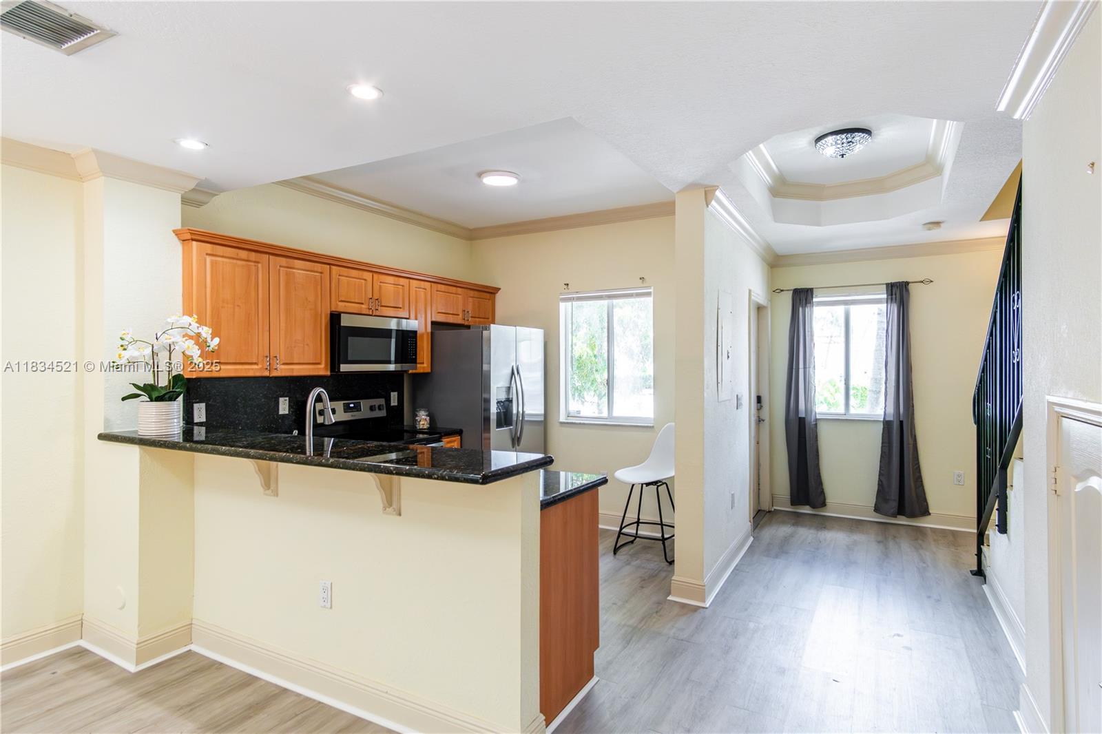 Move-In Ready Corner Townhouse-style Condo in 25-unit boutique Melrose Point, San Souci area of North Miami! Located across from the community pool. Brick-pavered entry opens to your spacious, light-filled unit with an open floor plan & 9' ceilings throughout. All stainless steel appliances, granite countertops. Privacy fenced patio. 2025 Updates: new refrigerator, dishwasher and microwave, new bathroom vanity in 1/2 bath. New lighting fixtures throughout. 2 assigned parking spaces. Community amenities: pool & dog park. Lovely, gated Melrose Point is a newer (2005) community close to the San Souci historic neighborhood. Minutes from a variety of dining, shopping, and entertainment options. Blocks to San Souci Tennis Center. Just bring your toothbrush.