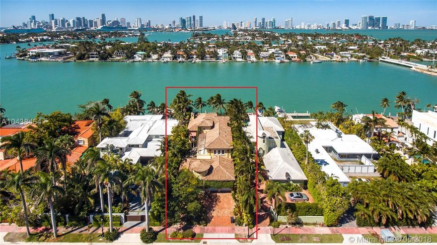 Live in the heart of South Beach and minutes away from everything. The best location off the Venetian Causeway. Minutes from Sunset Harbor and the beach. Enjoy the amazing sunsets  from the west-facing sun drenched pool. This is a boater’s dream with installed lifts and a built up travertine sea wall.  The home has 5 huge bd and 6 full ba and a 1/2 ba. The Master Suite fills the west-facing back of the house and includes an office and built out closets and leads to a covered balcony. A separate in-law suite overlooks a quiet courtyard. The main house boasts an open floor plan ideal for entertaining and flows naturally to the mosaic covered pool with the bay just beyond. The huge covered patio provides year-round outside enjoyment. Several French doors create inviting breezeways.