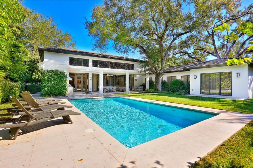 Contemporary custom-built home in gorgeous Ponce Davis neighborhood. Built in 2013, this stunning estate sits on a fully fenced & gated 20,000+SF lot with tropical landscaping. Designed with the finest finishes, the property features high ceilings with recessed lighting, floor-to-ceiling impact doors & windows & elegant hardwood floors. Perfectly distributed, the open floor plan features a grand formal living & dining room with wet bar overlooking the pool, gorgeous chef’s kitchen with stainless steel appliances, gas range & butler’s pantry, family room & office. Generous master suite with spa-like bath with tub, shower, double vanity, & 5 bedrooms with en-suite baths. Outside find a heated pool, covered patio with summer kitchen, full house generator, & 3-car garage.