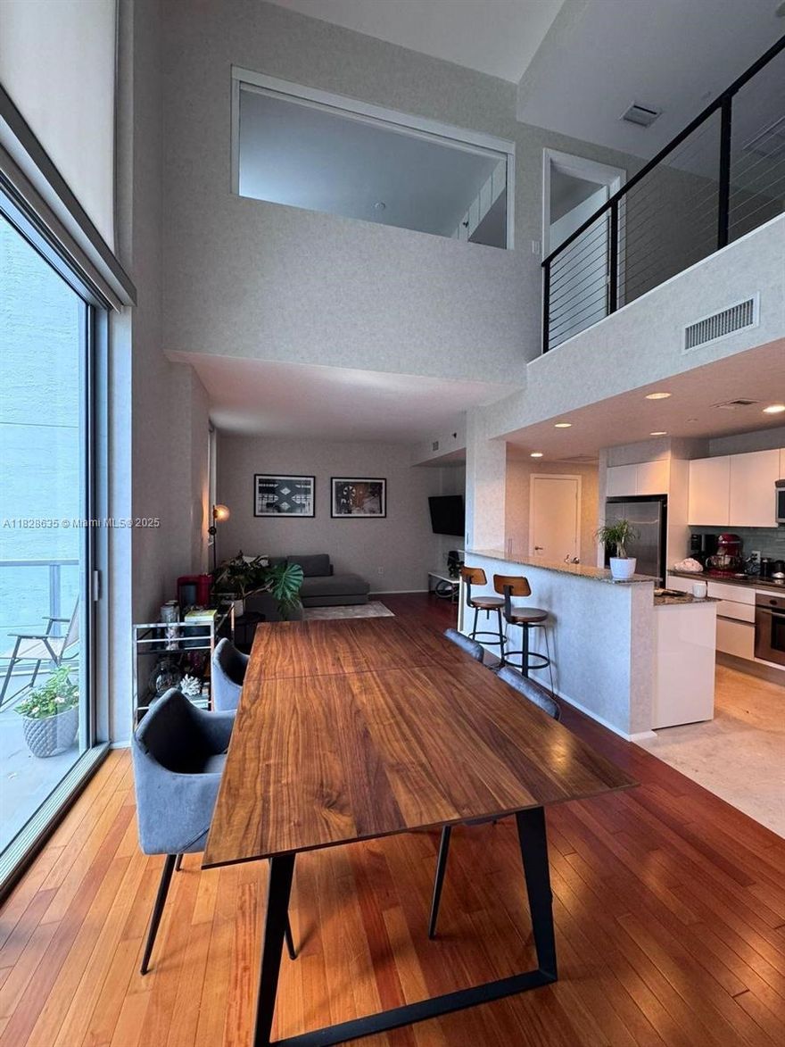 Rare corner duplex loft + den filled with natural light! Features Brazilian cherry wood floors, marble kitchen, and full bathroom upstairs with dual sinks, plus a guest half bath downstairs. Impeccably maintained and move-in ready. Parking on same 4th floor near elevator. Priced competitively per sq. ft. in a building with top amenities. Prime location—walk to shops, restaurants, and entertainment. A must-see!