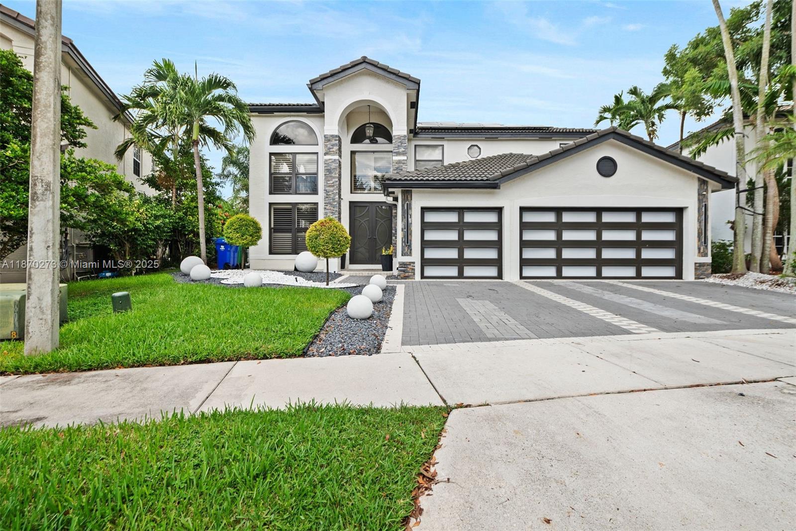 Stunning 6BD/4.5BA lakefront estate where no expense was spared in the remodel. This home features sleek porcelain floors, designer finishes, custom closets, and a spa-inspired primary suite with freestanding tub & oversized shower. Light-filled living spaces flow seamlessly into a gourmet kitchen and private gym area. Outdoors, enjoy a resort-style pool, covered pergola with full summer kitchen & bar, perfect for entertaining or watching the big game. Expansive lake views create the ultimate South Florida lifestyle.