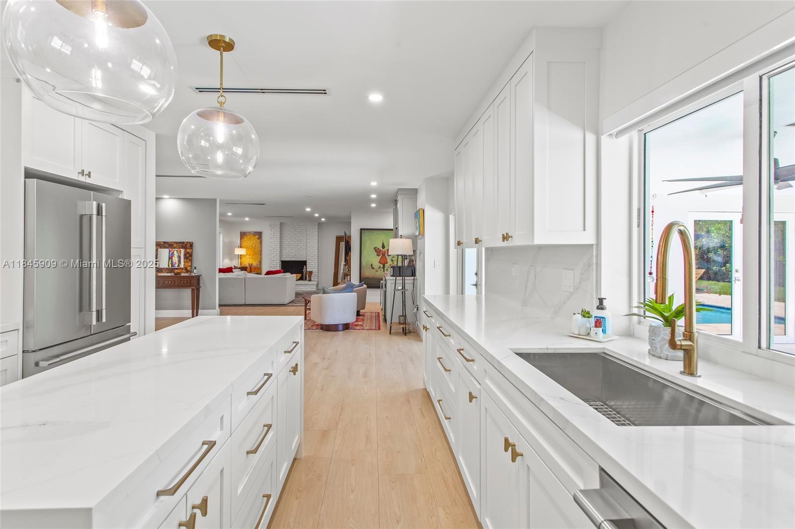 Fully Remodeled Canal-Front Home in North Palmetto Bay. Stunning contemporary residence with no expense spared. Features include all new PVC plumbing, impact windows and doors, a new saltwater pool with travertine deck, and a cozy working fireplace. The open-concept layout boasts porcelain tile flooring, plantation shutters, and a fully renovated kitchen with maple cabinetry, quartz countertops, and top-of-the-line appliances including a 36" induction cooktop. Beautifully updated cabana bathrooms and modern finishes throughout. Peacefully situated along the canal, just blocks from Old Cutler Road and minutes from parks, outdoor activities, and top-rated schools.