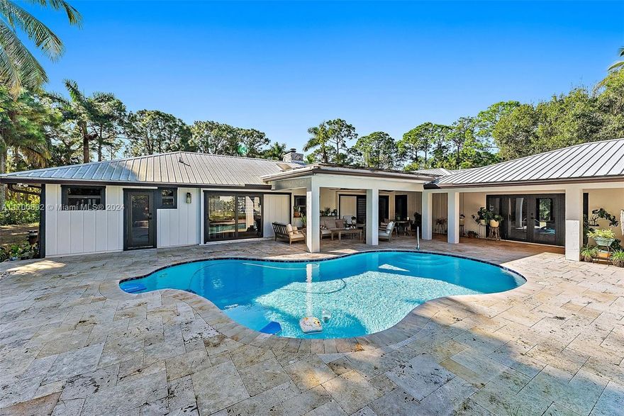 This recently renovated home has much to offer: Main home, a guest house, pool, detached workshop (20x25), and solar panels. Situated on 1.55 acres with mature trees and impressive landscaping this home is quiet and private while still easily accessible to restaurants, shops, parks and highways. Upon entering this home, vaulted ceilings and sliding glass doors flood the split floor plan with tons of natural light guiding you to wrap-around pool views and acreage. The primary is off the east side of the home with an absolutely stunning cabana bathroom complete with a walk-in closet. Off the third bedroom is an open addition, once planned and ready to be finished as a closed office.