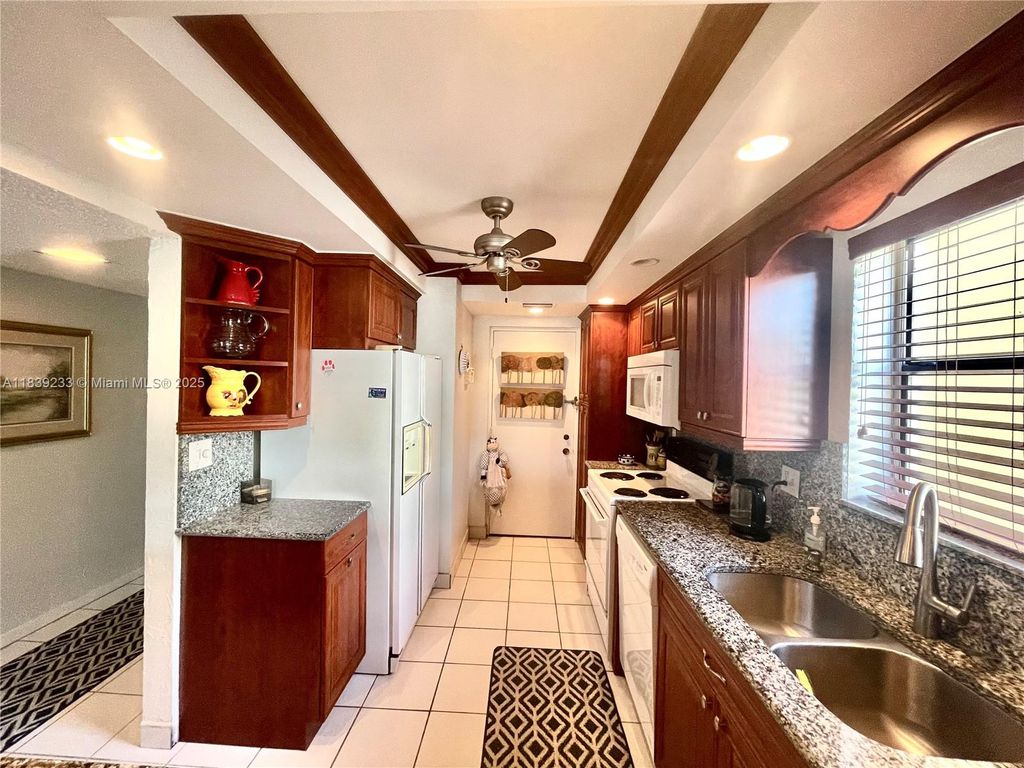 Photo of 2309 S Cypress Bend Dr #311D, Pompano Beach, FL 33069 (MLS # A11839233)