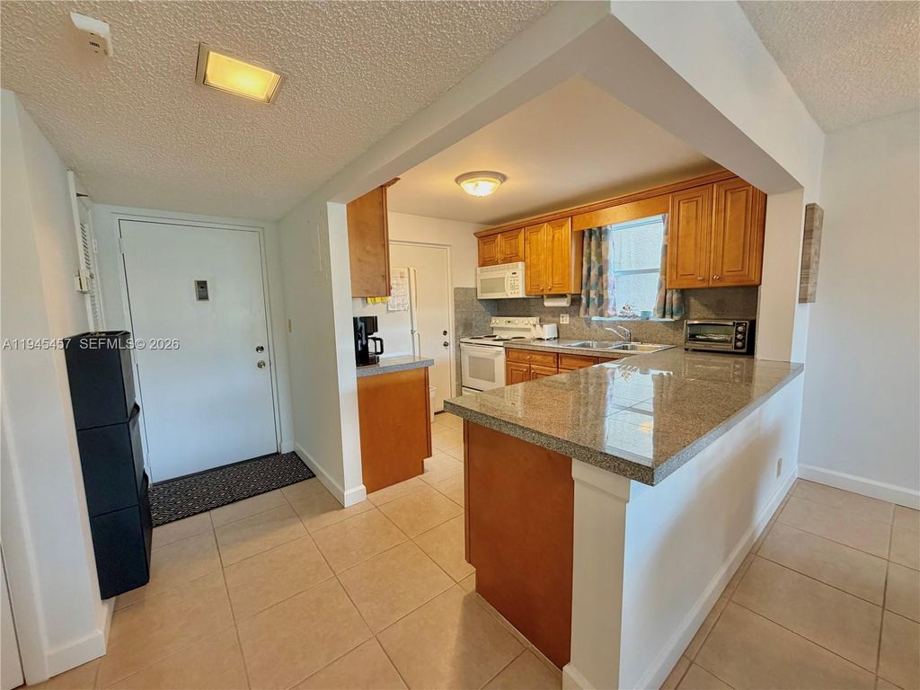 Photo of 2324 S Cypress Bend Dr #316, Pompano Beach, FL 33069 (MLS # A11945457)