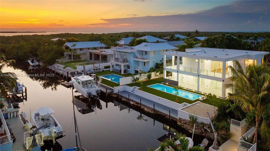 Experience the Ultimate Coastal Lifestyle at 107 Spoonbill - Your Oasis Awaits! Discover the epitome of coastal contemporary luxury in this breathtaking brand-new 4 bedroom/3 bath home. Immerse yourself in a world of resort-style living, where every detail has been meticulously designed to create an unparalleled living experience. Step into a realm of elegance as you enter through the ground-level foyer, greeted by the seamless blend of open living and kitchen spaces that effortlessly extend towards your very own private haven - a custom pool paradise overlooking the tranquil canal. Indulge your culinary passions in the kitchen of your dreams, a haven for discerning chefs and entertainers alike.