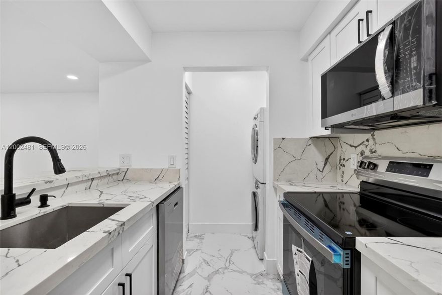 Beautifully renovated and move-in ready 1-bedroom, 1-bath condo in the heart of Pompano Beach! This unit has been substantially upgraded with a modern, clean design throughout, featuring elegant large-format porcelain tile flooring, a fully remodeled kitchen with quartz-style countertops, sleek white cabinetry, and all brand-new stainless steel appliances.

The open layout offers bright living spaces that flow seamlessly, enhanced by contemporary finishes, recessed lighting, and a stylish ceiling fan. The bathroom has been completely updated with a modern vanity, designer fixtures, and a glass-enclosed shower with custom tile work, creating a spa-like feel.

Additional features include in-unit washer and dryer, ample storage, and assigned parking. The community offers peaceful lake views, walking paths, and great amenities in a well-maintained setting.

Conveniently located just minutes from major highways, shopping, dining, and a short drive to the beach. A turnkey opportunity perfect for end users or investors looking for a fully upgraded unit in a desirable location.