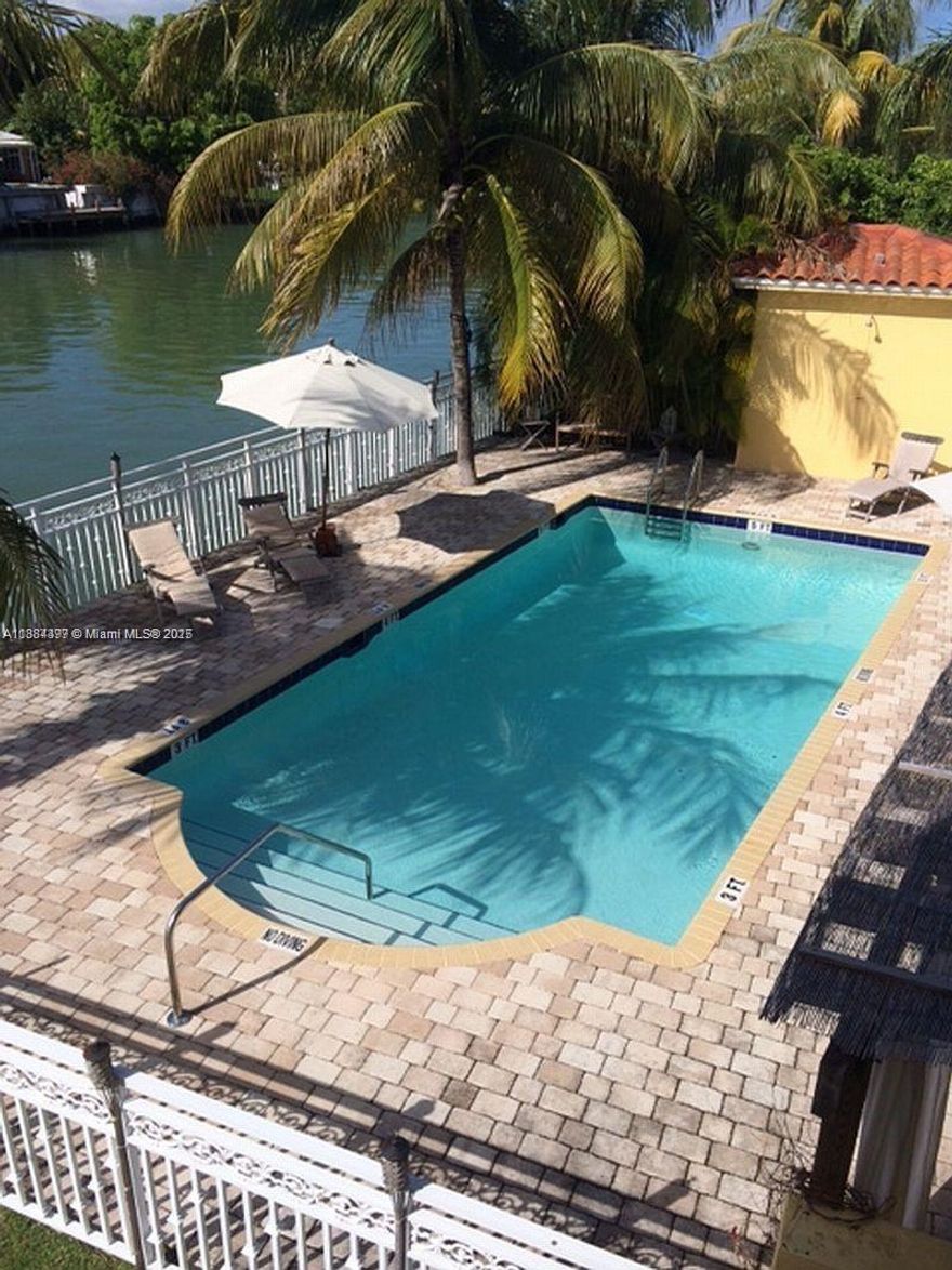 Charming waterfront building nestled between large mansions on quiet and prestigious Pine Tree Drive. This truly feels like living in a home; only 24 units in the complex which features a large deck/patio and pool right on the water; kayak or paddle board at your whim. A bright living room followed by a den/office space, dining area followed by the kitchen. Bedroom with large walk in closet. Washer and Dryer inside the unit and 1 gated parking space included. There's also guest parking for short term visits. Absolutely quiet serene living in the heart of a peaceful neighborhood located exactly within a 5 minute bicycle ride to the beach and various restaurants shopping of the 41st street corridor. Less than a 10 minute drive to South Beach.