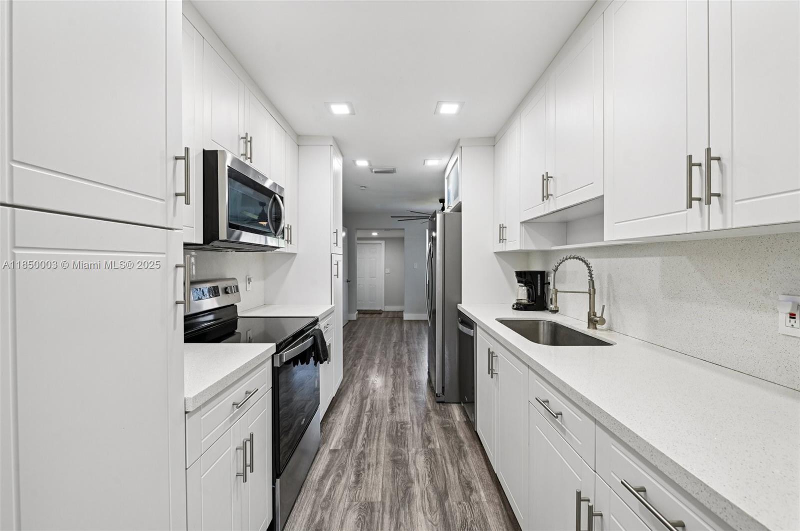 This home blends modern style with everyday comfort. Featuring a new 2023 roof, tankless water heater, impact windows and hurricane-rated doors for peace of mind. Modern laminated wood flooring and baseboards, complemented by a 2020 AC system. Enjoy the updated kitchen with gleaming quartz countertops and sleek stainless steel appliances. Both bathrooms offer refined finishes & fixtures. Den/office room with closet acts as an additional room for more space. Outside, the large yard has space for a boat or RV, a driveway for multiple cars. Abundant natural light, enhanced by recessed lighting creating a clean, open feel. Located just 2 minutes from the beach, shopping, dining, and major routes, this home offers a perfect balance of style and location. No HOA!