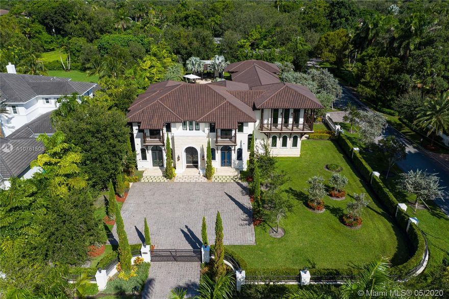 The Italian villa located on Pinecrest's best street . Enjoy the impeccable high end finishes in this expansive 8BD/9 + 1 BA 11,400 SF custom built home. The formal entry leads to a winding stair case. An immaculate wine cellar, elevator, library/office & open kitchen/ family room. Marvel in venetian plaster walls, vaulted ceilings, intricate marble/stone details & views to the pool, spa & lushly manicured grounds. Contemporary home comprised of 2 marvelous master suites( Yes 2 master bedrooms) and 5 in suit bedrooms with walk in closets. Close to Pinecrest Elementary & A+ schools. Walking distance to Gulliver Preparatory School. Generator ready. 4 car garage (840 sq ft.) 3 separate and automated gated entrances. Heated pool and a fantastic outdoor kitchen.