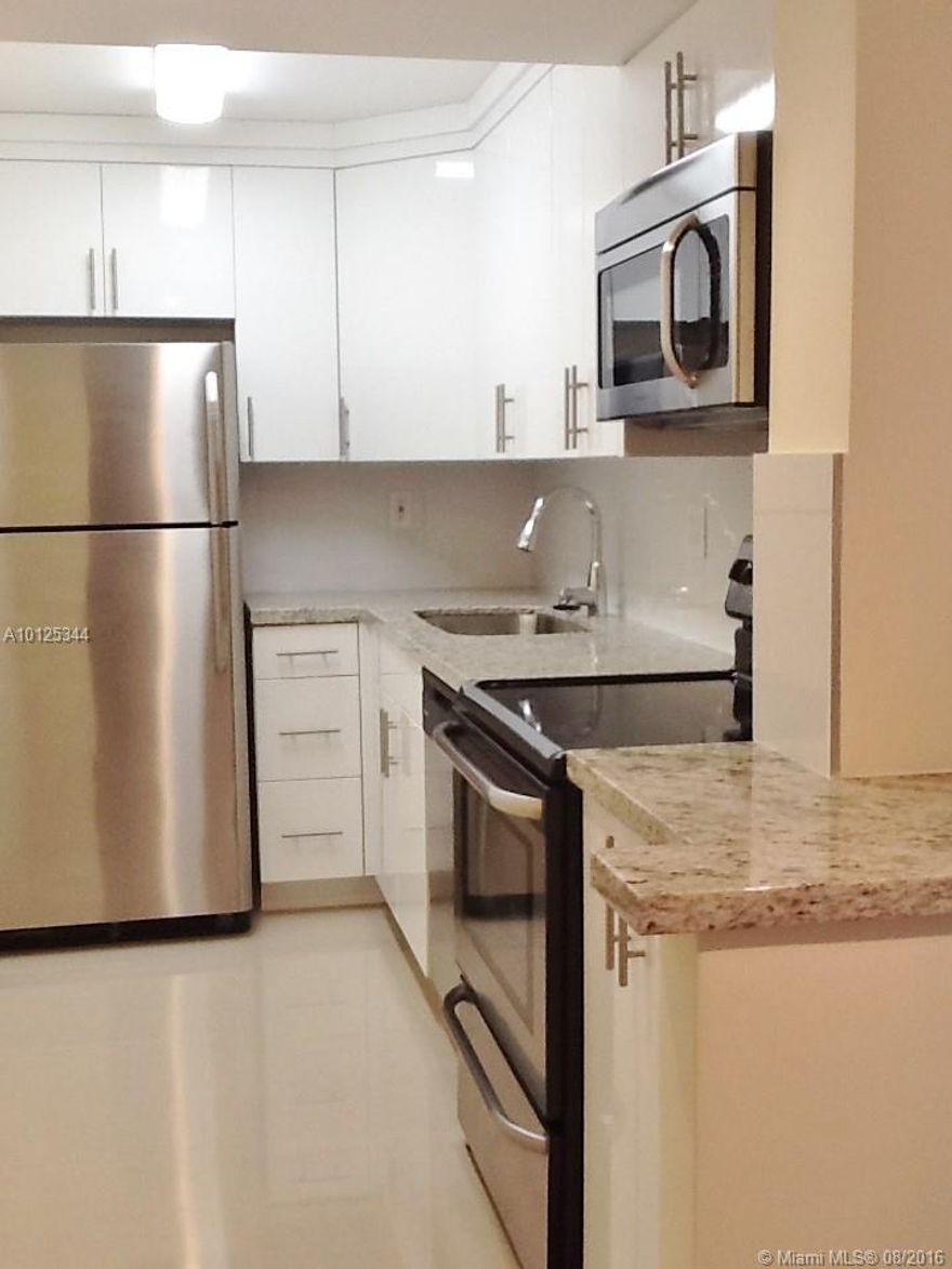 Complete renovation of beautiful 2 bedroom, 2 bathroom unit. Split floor plan with ensuite bathrooms. Sleek new tiled floors throughout, granite counter tops, stainless steel appliances, new ac, new water heater, new plumbing. Master bedroom with walk in closet. 1 assigned parking space and additional guest parking available. Great location near palmetto expressway, and Miami Int'l Airport. Gated community with security. No washer/dryer in unit; Three laundry rooms in building. Community pool.