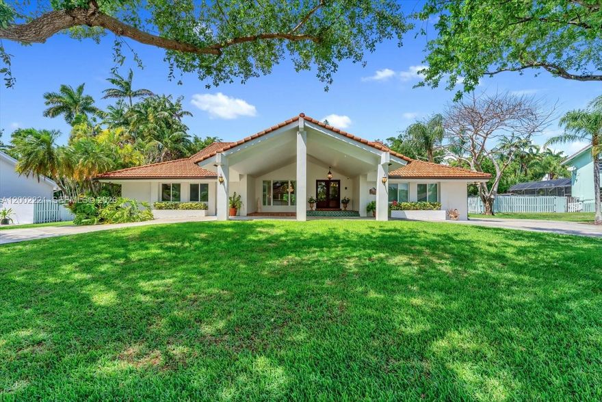 Welcome to this beautiful residence in the highly sought-after Falls neighborhood. A charming porte-cochère welcomes you home, offering shade & protection from the rain. Custom wrought-iron gates on both sides of the front entry—as well a custom railing inside the foyer—add a touch of elegance as you step into the formal living and dining rooms, highlighted by volume ceilings and an airy, inviting feel. Elegant impact glass double door entry.  This spacious split-floor-plan home features 5 bedrooms & 3.5 baths, including a bedroom currently used as an office plus a flex room with serene pool views—ideal for quiet, Zen-inspired moments. The home is equipped with a newer tiled roof (2018) and full impact windows and doors throughout. The updated primary bathroom includes a large spa tub perfect for unwinding and relaxation. The updated kitchen offers a cooking island, breakfast area, and excellent flow to the surrounding living spaces. A very convenient utility/storage room adds everyday practicality. Natural lighting fills the home, creating a warm and pleasant ambiance. 
Step outside to a generous covered patio designed for entertaining, overlooking an extra-large pool and private backyard. Heated salt-water pool. Located on a quiet street and in a No Flood Zone, this home offers comfort, functionality, and peace of mind.