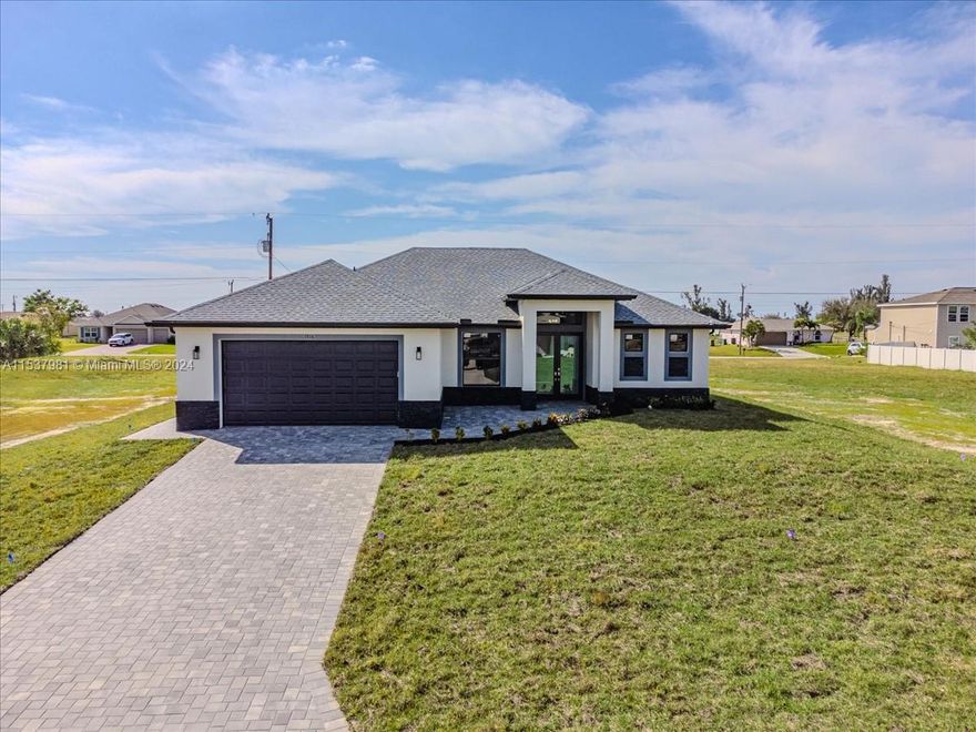 **$12,000 SELLERS CREDIT TOWARDS CLOSING COSTS**PUBLIC WATER connected with ASSESSMENT PAID** Welcome  to this beautiful modern property built in 2024 in the growing Northeast area of Cape Coral City. Designed with 3 Bedrooms, an Office and 2 baths. Open concept design with PORCELAIN TILES floors throughout, HIGH ceilings over 9.4” in each room, fans in every room, tankless water heater, IMPACT WINDOWS and DOORS, gutters, kitchen features a big island with quartz countertop, stainless steel appliances, self cleaning oven, 36” modern cabinets with soft close, the Den has barn doors. This  home is 3 minutes away from major roads, grocery stores, medical urgent care and restaurants.  NO HOA and NO FLOOD INSURANCE REQUIRED.  Schedule a private showing today!