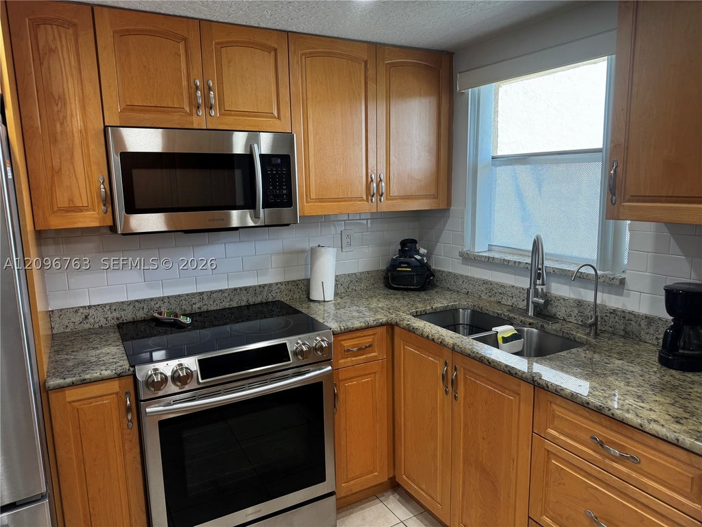 Photo of 8435 Sunrise Lakes Blvd #211, Sunrise, FL 33322 (MLS # A12096763)