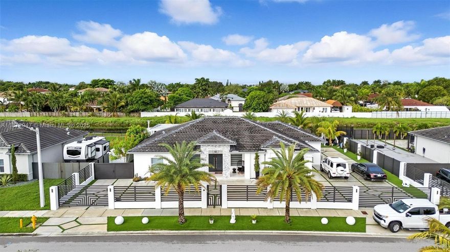 Stunning Miami residence reimagined with luxury upgrades, smart technology, and resort-style amenities. From the moment you arrive, electric gates open to a beautifully designed property. Inside, impact windows, smart lighting, and a Sonos sound system blend security and comfort. The home also features a Rain Soft water treatment and Air Master Ultra purification system for the highest quality of living. Outdoors, enjoy a saline pool with heater and jacuzzi, artificial grass, and an elegant pergola with BBQ, fireplace, stove, TV, ice maker, and granite countertops—ideal for entertaining. Relax by the canal or explore the Black Creek Trail just beyond your backyard. With boat storage space quality fencing, and negotiable furnishings, this home is turn-key. More than a home it’s a lifestyle.