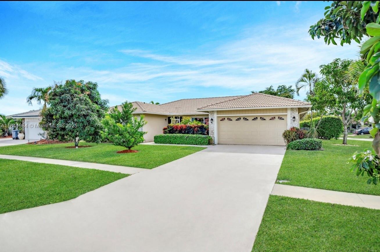 Renovated Corner Lot Home with 3 Bedrooms, 2 Baths, 2-Car Garage, Pool, and Lake Views in the prestigious Boca Greens Country Club—a gated golf community. Features include hurricane-proof impact windows and the door, cathedral ceilings, crown molding, tile and laminate flooring, recessed lighting, and surround sound. The gourmet kitchen boasts granite countertops, stainless steel appliances, and ample cabinet space. The spacious master suite includes vaulted ceilings, three walk-in closets, and pool access. Fully renovated bathrooms offer floor-to-ceiling tile and dual sinks. The backyard oasis has a screened patio, sparkling pool with mosaic designs, and serene lake views with native wildlife. Pet-friendly, all-ages community with top-rated schools and nearby houses of worship.