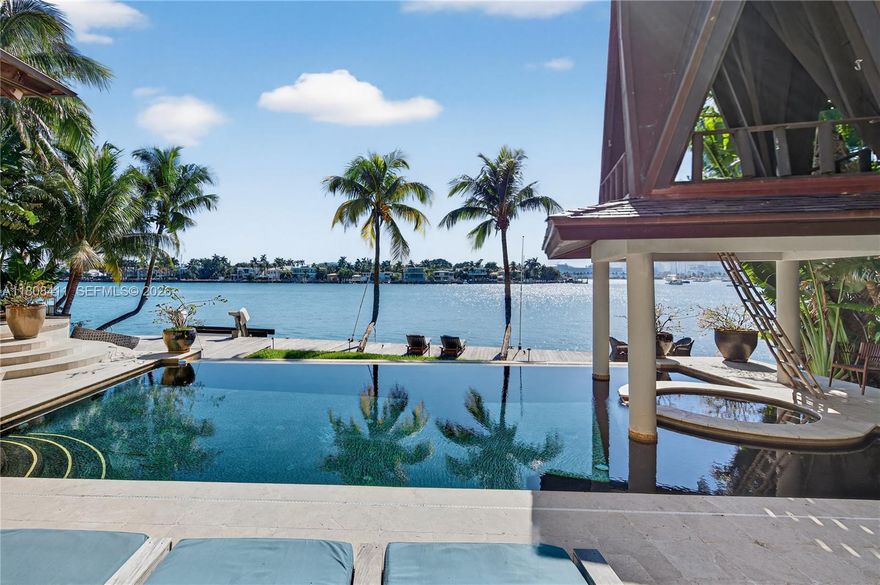Nestled on the prestigious Venetian Islands, this Balinese-inspired sanctuary offers highly coveted SW-facing sunset views over downtown Miami's skyline with over 100 feet of water frontage on pie-shaped 13,000 sqft lot. Designed for relaxation and entertaining, the property features over 8,000 sqft of indoor/outdoor living. Features include outdoor kitchen, dining, oversized infinity pool with waterfall feature and hot tub, crowned by a unique over-water zen cabana. The home features an expansive primary suite plus 5 additional bedrooms, each with its own bathroom. With a cozy movie room, sauna and wellness-focused amenities, this distinctive retreat combines warm elegance with breathtaking views in one of Miami Beach's most desired locations.