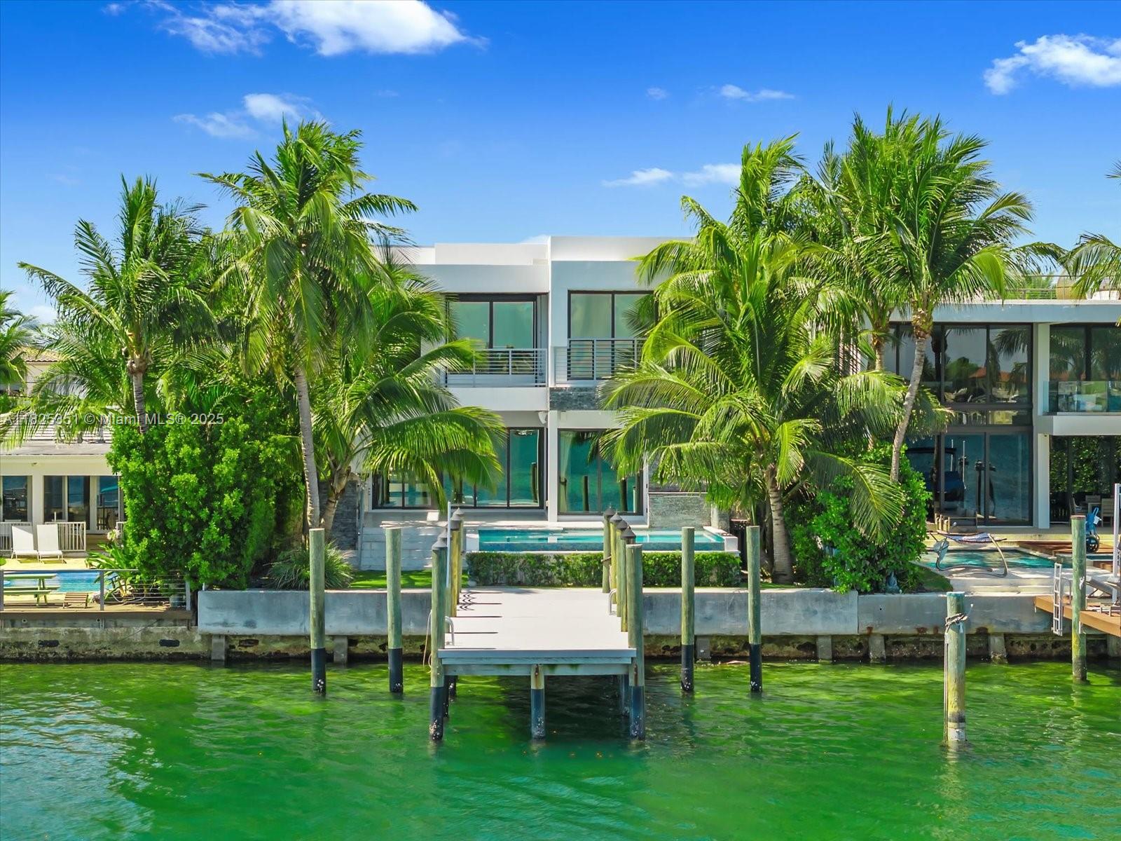 This magnificent modern masterpiece in the prestigious Stillwater Dr guard-gated community at Biscayne Point. This spectacular residence was built in 2021, this home offers a sleek and contemporary design with meticulous attention to detail and high-end finishes throughout, this property sets a new standard for luxury living. The home features a brand new dock and seawall, providing convenient access to the water. A spacious and open floor plan, perfect for entertaining and modern living. From the custom cabinetry to the top-of-the-line Miele appliances, ample storage space, and a large center island with seating. This modern masterpiece, along with its stunning rooftop showcasing 360-degree views, provides an unmatched level of luxury, elegance, and outdoor entertainment options.