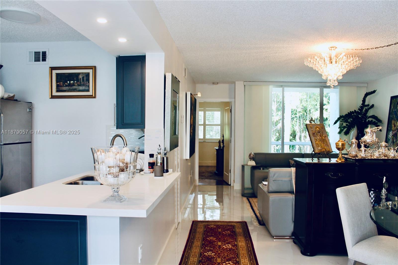 Beautifully renovated 1 bedroom, 1.5 bath apartment located in a secure and calm gated community in the heart of Doral. Just minutes from major highways and within walking distance to shopping centers, restaurants, pharmacies, and more. The unit features a modern kitchen with marble countertops, elegant marble flooring throughout, and upgraded bathrooms with porcelain finishes. High ceilings create a bright, spacious feel, while new doors and custom plantation shutters add style and privacy. Washer and dryer are conveniently inside the unit, with parking directly in front. The HOA covers water, security, and landscaping, making life easier. The apartment is sold fully furnished with tasteful décor, completely move-in ready, and very easy to show.