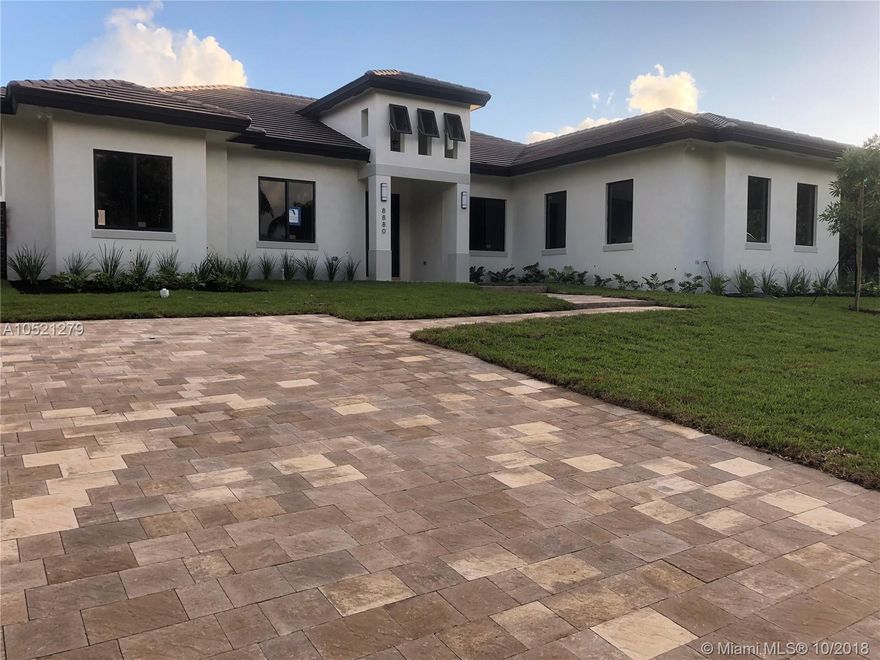 New Construction corner lot, contemporary style features 4 bedrooms, 3.5 bathrooms including Cabana Bathroom. Beautiful State-of-the Art design with travertine floors in common areas and wood floors in bedrooms. Tile in covered terrace, paver driveways. Large size hurricane proof windows and exterior French doors, 10 ft. ceiling with tray ceiling in common areas, 8 ft. doors, wood cabinets with quartz counters in bathrooms and kitchen, wood cabinets in Laundry. Large backyard with large pool, oversized Garage for two cars and space for 6 additional cars in driveway. Designer bathrooms with porcelain in floors and shower, frameless glass shower doors. All kitchen high efficiency appliances and high efficiency Air Conditioning equipment, LED light fixtures throughout the house. Fenced patio.