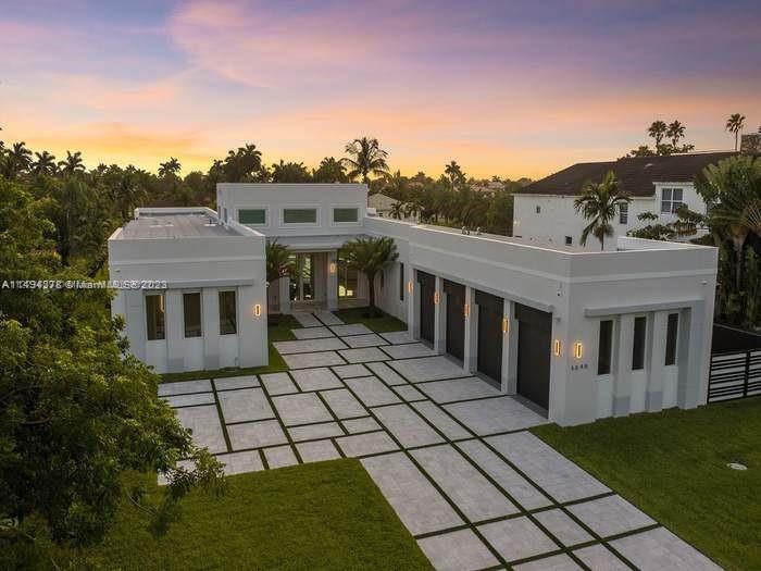 Welcome to the pinnacle of modern luxury! This brand-new 2022 home sits on a spacious 30,492 square foot gated lot. With 5 bedrooms and 6 bathrooms in an open floor plan, it's a contemporary masterpiece. Experience the perfect blend of elegance and practicality, featuring high ceilings, sleek porcelain floors, and abundant natural light. The kitchen is a chef's dream with quartz countertops and Thermador appliances, flowing seamlessly into the family and dining areas. The master suite boasts his and her walk-in closets with a spa-like bath. Step outside to discover a sprawling outdoor retreat with covered terraces, a deluxe summer kitchen, and a luxurious pool/spa amidst lush greenery. Impact windows/doors, laundry room, an extensive gym facility situated in a spacious 4-car garage.