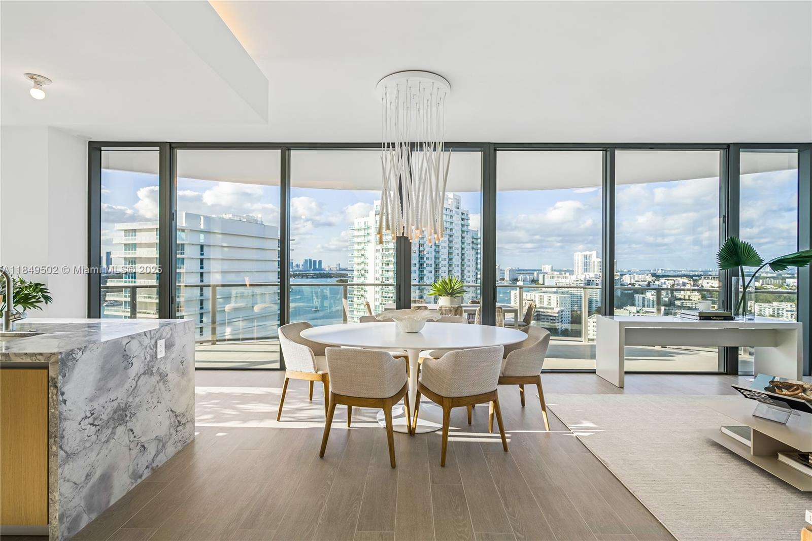 This sophisticated two-bedroom, two-and-a-half-bath corner residence at Five Park offers sweeping views of the ocean, Biscayne Bay, and Canopy Park. With floor-to-ceiling windows and north-facing exposure, it features porcelain floors, a gourmet kitchen with Gaggenau appliances, and Italian cabinetry. Both bedrooms have en-suite baths, plus a stylish powder room. Enjoy a bayfront pool, 24-hour fitness and co-working studios, spa, on-site restaurant, and exclusive beach club access in South of Fifth with dedicated chairs, umbrellas, and food and drink service.
