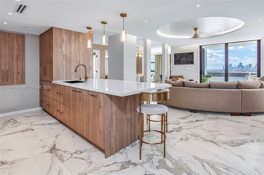 Step into a world of unparalleled luxury and breathtaking views at 9 Island Ave Unit 2104. This stunning 2-bedroom, 2-bathroom residence is perched high above Biscayne Bay, showcasing sweeping vistas of the bay, the Miami skyline, and magical sunsets.

Gut renovated in 2022 with the space completely re-imaged, the interiors blend modern elegance with timeless comfort. Every design detail is impeccably thought through. The open-concept living space is flooded with natural light, featuring sleek finishes and floor-to-ceiling windows that frame the unmatched views from every square inch of this home. The gourmet kitchen boasts top-of-the-line appliances, custom cabinetry, a concealed coffee area and an inviting peninsula, perfect for entertaining or indulging in a quiet morning coffee.

The primary suite is a serene retreat with a spacious custom walk-in closet, a spa-like  bathroom with oversized shower and separate water closet, and dual vanities with lighted mirrors.

Located on the iconic Venetian Islands, 9 Island Avenue is a full-service building with resort-style amenities, including a waterfront pool, marina, tennis courts, a state-of-the-art fitness center, and 24-hour concierge service. Just steps from vibrant Sunset Harbour, you'll enjoy boutique shopping, trendy dining, and easy access to Miami Beach’s best offerings.

You won't find a better designed 2, 3, or 4 line in this building, or a nicer unit this size, with these views on Belle Isle.