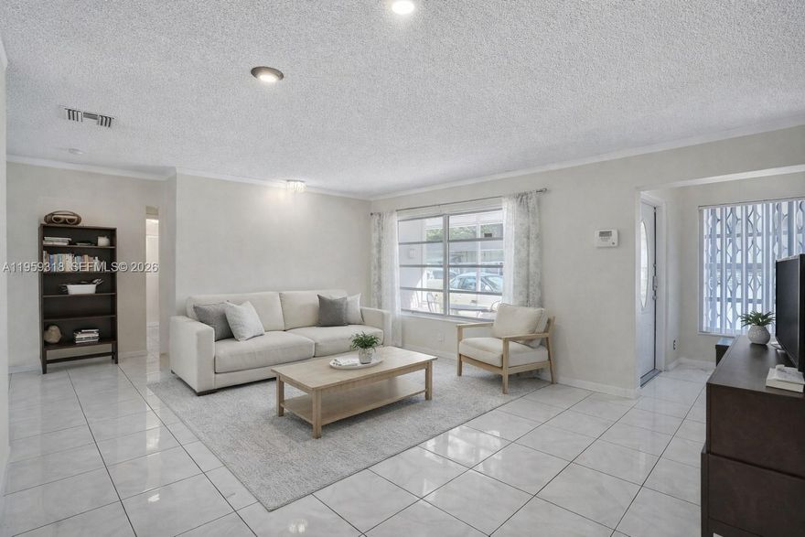 2-bedroom, 2-bath single-family home on a quiet canal in Tamarac with over 1,500 sq ft of living space and water views. Features ceramic floors, a formal dining area, additional space for office or den, and a screened porch. Curved tile roof, circular driveway, hurricane shutters, and washer and dryer included. Located in the Mainlands of Tamarac Lake, a 55+ community with low HOA fees covering lawn care and exterior maintenance, close to shopping, dining, and parks.