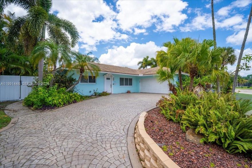 BEST-PRICED HOME IN JENADA ISLE, WILTON MANOR! Exceptional opportunity to own in this prestigious gated community. Offering 2,000+ sq ft under air on an oversized 8,495+ sq ft lot, this move-in ready home features a desirable split floor plan, spacious primary suite, and generously sized guest bedrooms. Impact windows & doors, open-concept kitchen, crown molding throughout, and abundant natural light. Private backyard with mature fruit trees, perfect for relaxing or entertaining. Additional highlights include tile roof (2001), A/C only 10 months old, oversized laundry room, circular driveway, and gutters for added protection. Prime location near Wilton Manors, Fort Lauderdale, beaches, dining, shopping, and I-95. Ready for you to move in and make it your home. Recently appraised at $800,000, submit your highest and best offer.