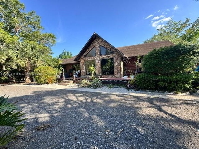 This is a fantastic opportunity to own a beautiful chalet-style home on 2.5 acres in Montura Ranch Estates, free from any association fees or restrictions. Located just one hour from Miami, this property offers a tranquil escape from the city's traffic, allowing you to enjoy the peace of a country community. The home features three bedrooms, two bathrooms, and an additional guest room. !!!Don't miss out on this unique property!!!