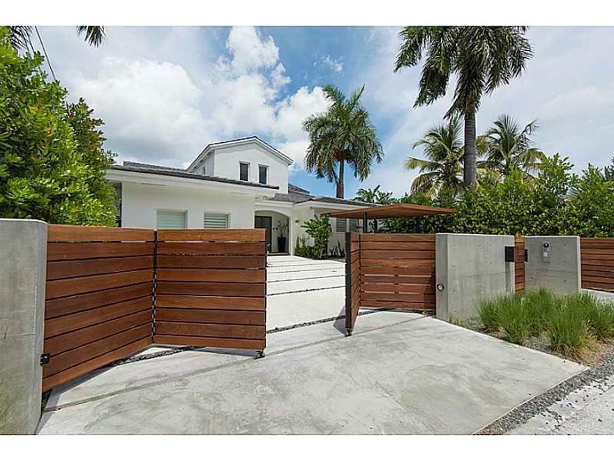 Palm Island Contemporary Waterfront Masterpiece. Fully remodeled in 2014 to modern tropical style, home has a spacious open layout, 4 beds/4.5 baths, soaring ceilings, panoramic impact windows, ocean-view master bath, and ocean-view 2nd story deck with ho t tub connected to bedrooms. Perfect for entertaining with free-form zero-entry pool, covered BBQ area, open white marble kitchen with stainless steel chef's kitchen; custom floors, décor, and lighting throughout; endless Biscayne Bay and city views.