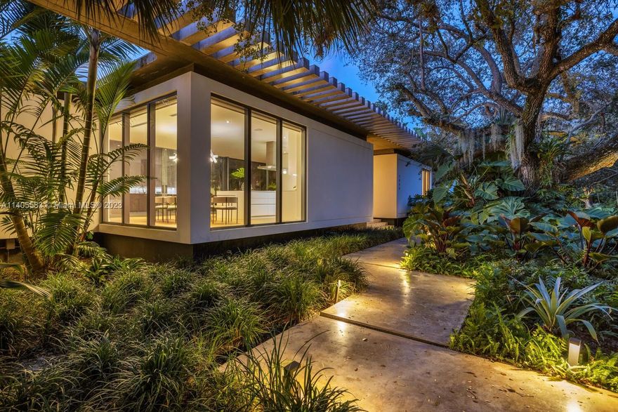 Welcome to Whispering Pines. This signature single-story residence exemplifies “tropical modernism” at its best. Designed by internationally renowned Brillhart Architecture, this courtyard complex is comprised of 6 seamless building structures separated by 5 pocket gardens nestled around the perimeter, with an elegant landscape-injected façade throughout the entire home. The pleasingly landscaped courtyard features a grand 80’ sparkling pool, visible from almost every corner of the home. Fantastic features: covered pergola, enclosed tree house, zip line, outdoor kitchen, guest quarters/gym, multiple flex rooms/office, staff room, three car garage, generator and gas, plus numerous fruit trees and wondrous majestic oaks that embellish this fully gated compound in highly desirable Pinecrest.