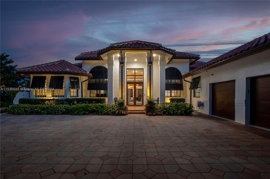 Create your memories in this exquisitely updated residence nestled in exclusive Crystal Grove Estates where luxury and privacy blend. Be captivated by the refined but casual feel of this home with 5 bed/5 bath +office +bonus rm. Set on a builder’s acre waterfront lot, the backyard oasis is ideal for relaxing at the 40x30 pool or dining alfresco around the summer kitchen. Step inside and fall in love w/the chef's kitchen w/custom cabinetry, top-of-the-line appliances and every culinary convenience imaginable. Interior has the warmth of wood flooring, stunning fixtures, unique moldings and volume ceilings. All bedrooms are ensuite. Impact windows and doors ensure hurricane protection. Roof 12 yrs. Full house Generac generator. 3 car garage w/epoxy floor, work area and car lift. A must-see!