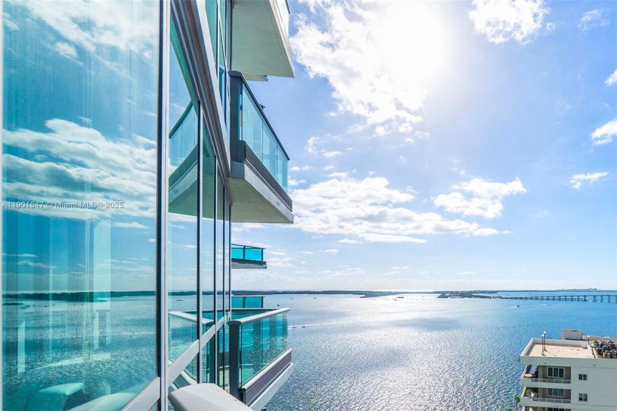 Experience elegant waterfront living at Jade Brickell from this sophisticated corner residence showcasing panoramic views of Biscayne Bay, the ocean, and the Brickell skyline. Floor-to-ceiling windows and a wraparound terrace create seamless indoor-outdoor flow. The private elevator opens to a light-filled foyer leading into a spacious split two-bed, two-bath layout. The open kitchen features Miele and Sub-Zero appliances, sleek maple cabinetry, and granite countertops. Enjoy resort-style living with concierge services, bayfront pools, a state-of-the-art fitness center, spa, sauna, and more. One assigned parking space plus valet for a second car and guests. Perfectly located steps from Brickell’s premier dining, shopping, and entertainment.