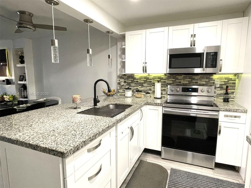 Primary Home or Investment opportunity with no rental restrictions. This spacious 2-bedroom, 2-bath condo is located in a highly desirable gated community in the heart of Tamarac. Renovated Kitchen with granite and SS Appliances, as well as renovated and modern bathrooms. Also features ample sized bedrooms with walk-in closets, and a large screened balcony with tranquil lake view. Washer and dryer inside the unit.  The community offers amenities, including roaming security, pools, a clubhouse, tennis and racquet courts, BBQ/picnic area among others. Water is included in the association fees. There is an assigned parking space and ample guest parking available for both residents and visitors. Fast association approval. Current special assessment of $54 for 5 years, plus $501 HOA, for a total of $555 maintenance a month. There are no other assessments coming. 40 years inspection PASSED.