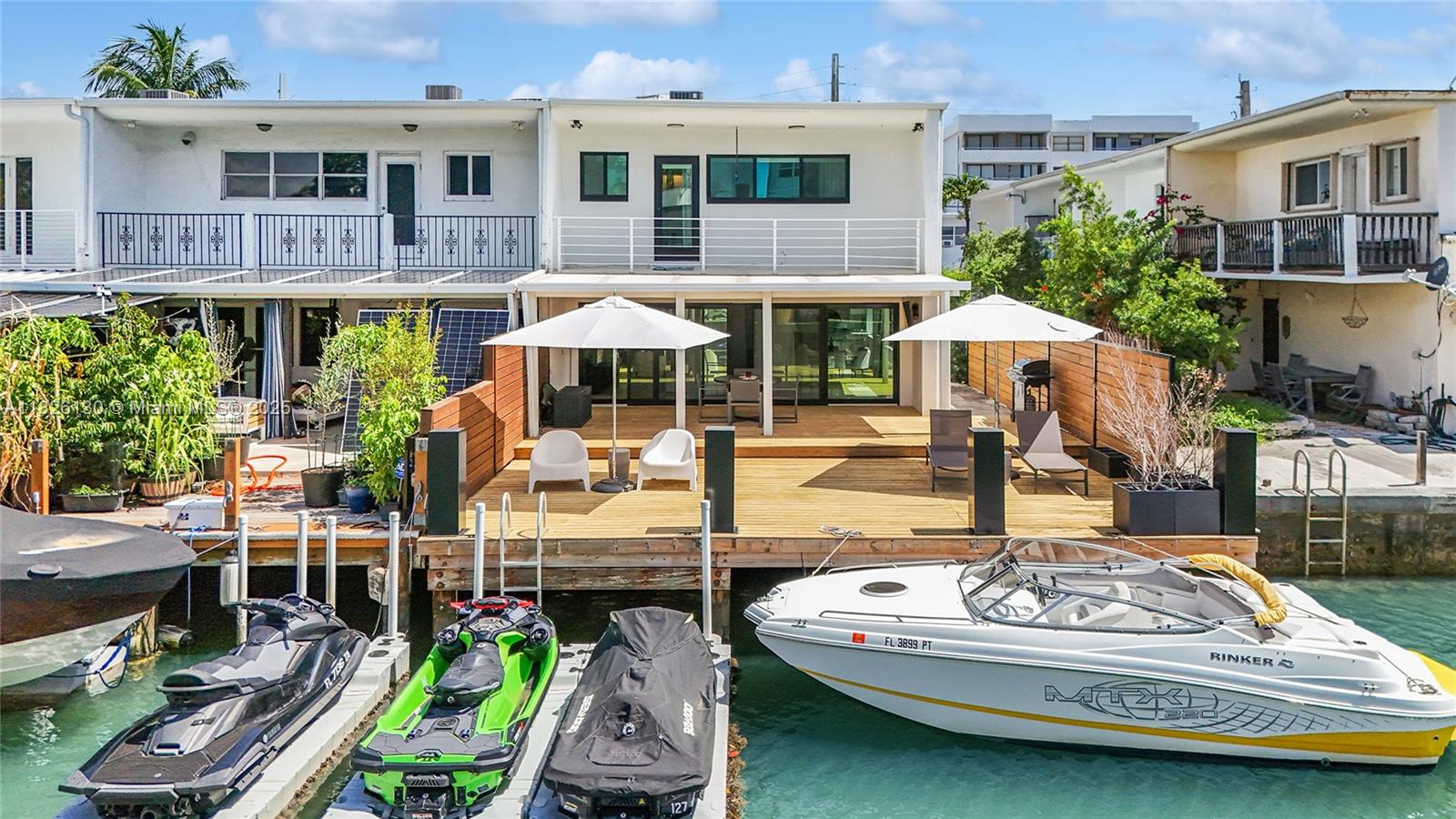 Absolute SHOWSTOPPER. Private, gated enclave with a private boat dock and no bridges to the Bay. 31' of waterfront with a sensational back deck perfect for entertaining. Fully gated and private, the entrance & front driveway accommodates 6 cars easily. The interior sparkles with imported porcelain & hardwood floors, a wide open leather-finish granite & stainless steel kitchen, impact windows & doors, 3 beds & 3.5 baths. Absolutely seamless indoor~outdoor flow with a flawless covered patio & BBQ deck overlooking the water. The location is incredible. Easy stroll to the beach, right across from the park, just steps to to sushi, gelato and incredible dining & nightlife. Hottest area of Miami Beach. There is absolutely nothing like this available, ever. Call today, this will sell immediately.