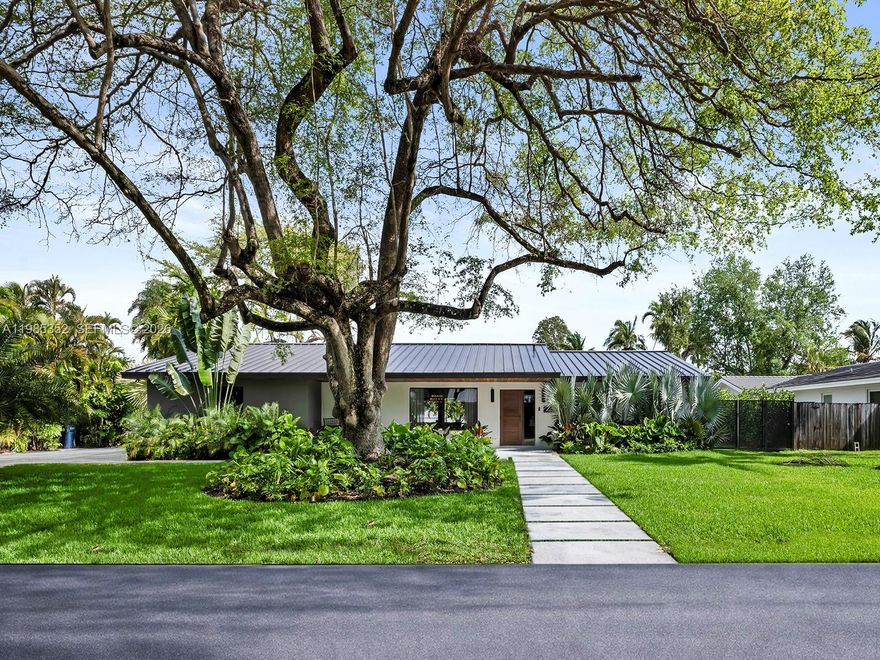 Fully remodeled modern residence in prime Palmetto Bay, just minutes from Pinecrest, offering a rare combination of design, functionality, and location. Set on a 14,947 SF lot, this 4-bedroom, 3.5-bath home spans over 2,900 SF under AC and was completely reimagined by Meta Development in 2025. The open-concept layout is filled with natural light and enhanced by architectural details including a floating staircase, skylights, custom millwork, and designer LED lighting. The kitchen is designed for both everyday living and entertaining, featuring custom cabinetry, porcelain countertops with waterfall island, Samsung appliances, wine and beverage refrigerators, and Hansgrohe fixtures. The primary suite is a true retreat with a spacious layout and an oversized, fully built-out walk-in closet. Custom cabinetry and built-ins extend throughout the kitchen, pantry, bar, closets, and bathrooms, delivering both design and function. Porcelain tile flooring runs seamlessly throughout the home. Additional upgrades include a metal roof, new electrical panel, AV system, recessed lighting, and two EV charging outlets. Outdoor spaces are thoughtfully designed with lush landscaping and a heated pool, creating a private, move-in-ready environment. Located near top-rated schools, parks, and the best of Palmetto Bay and Pinecrest living.